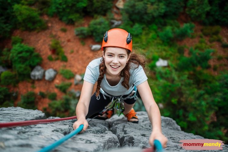 Image of a teenager rock climbing